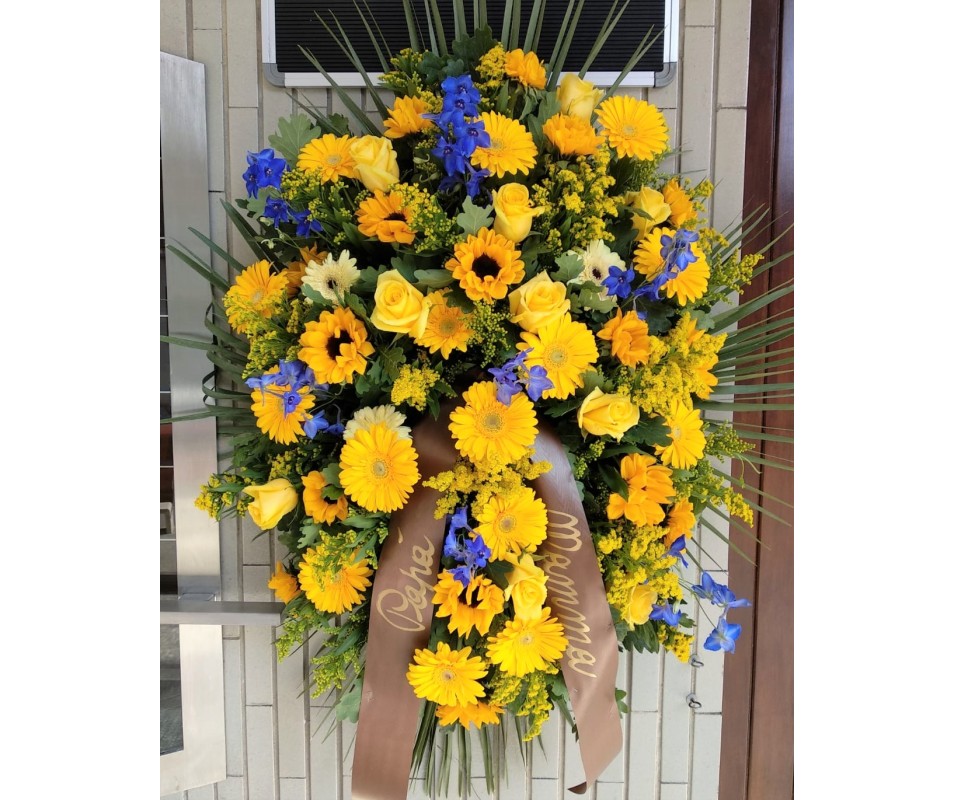 Cuscino funebre di fiori gialli e blu